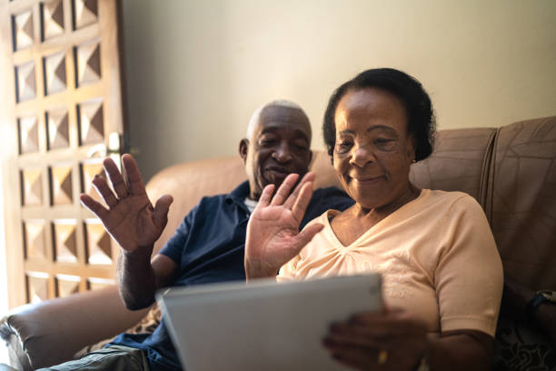 Happy Black elderly couple sitting together smiling