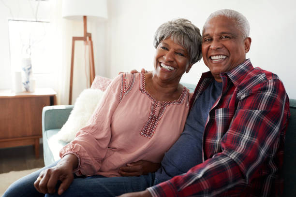 Warm Black elderly couple embracing with genuine smiles